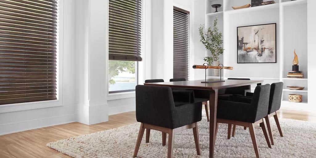 Bright interior with large windows and wooden blinds.