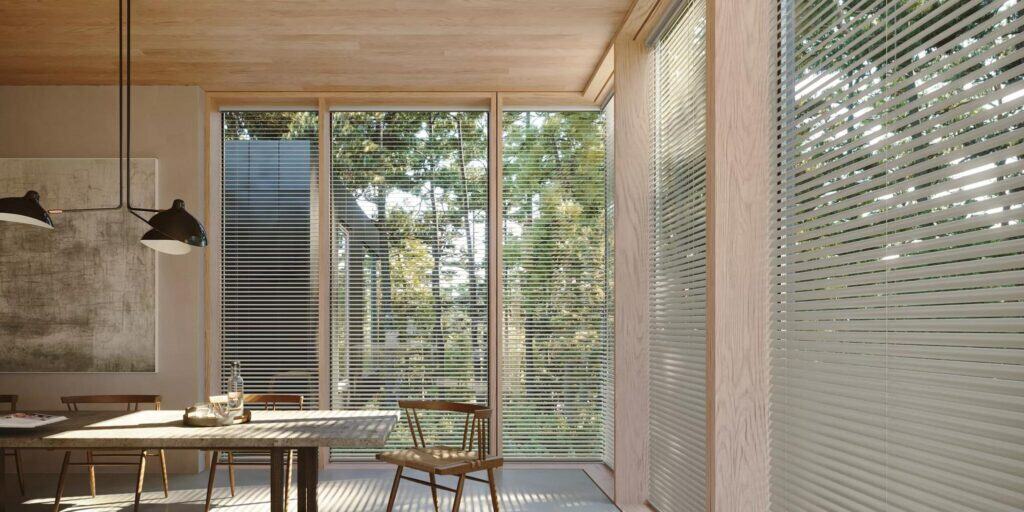 Bright dining space with expansive windows, wooden ceiling, and stylish blinds for natural light and indoor-outdoor connection.