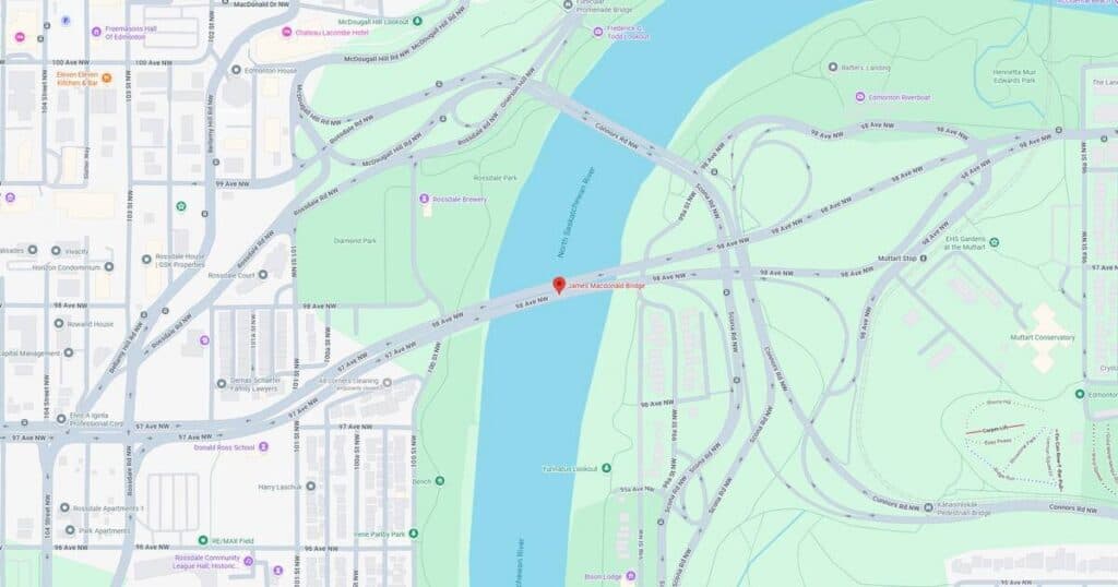 Scenic riverfront park featuring walking trails, lush greenery, and recreational areas in a city setting.